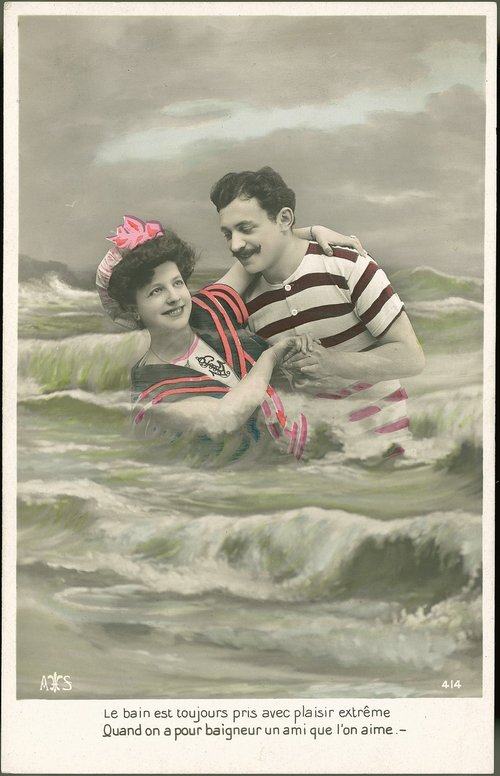 Edwardian Beach Romance: Hand-Colored Couple in Ocean Waves
